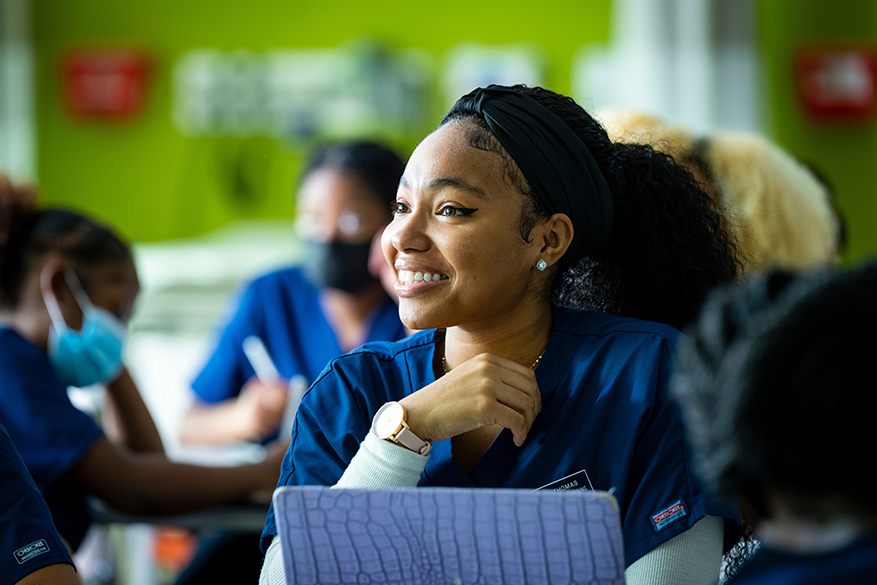 black woman in navy scrubs