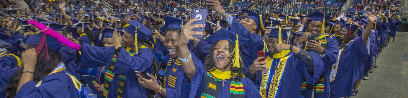 Excited N.C. A&T graduates in caps and gowns celebrate at commencement, holding diplomas and taking selfies. The graphic highlights 14,311 students enrolled in Fall 2024, 95 degree programs, and 2,274 bachelor degrees awarded in 2023–2024.