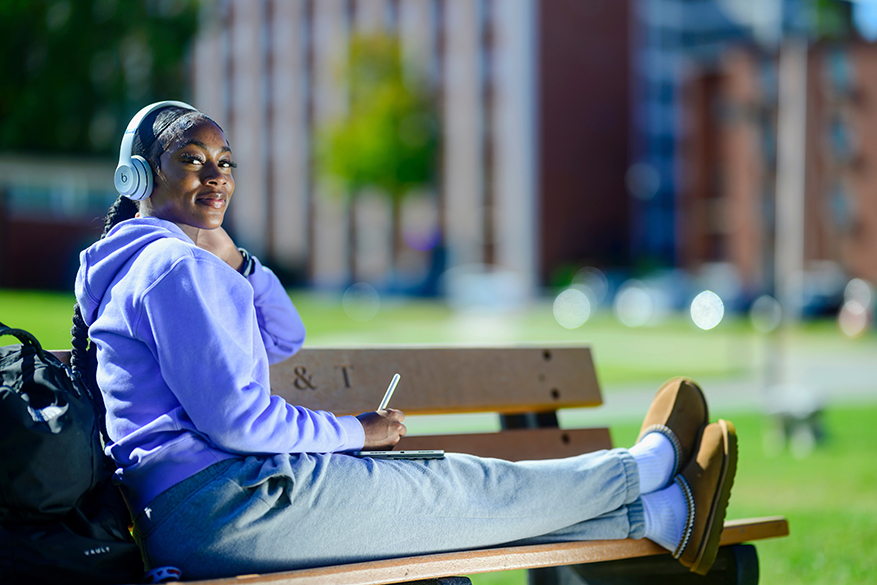 a female student on the park bench
